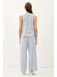 Woman wearing blue striped linen pantsuit paired with Boho striped Henley tank, stylish womens boho clothes