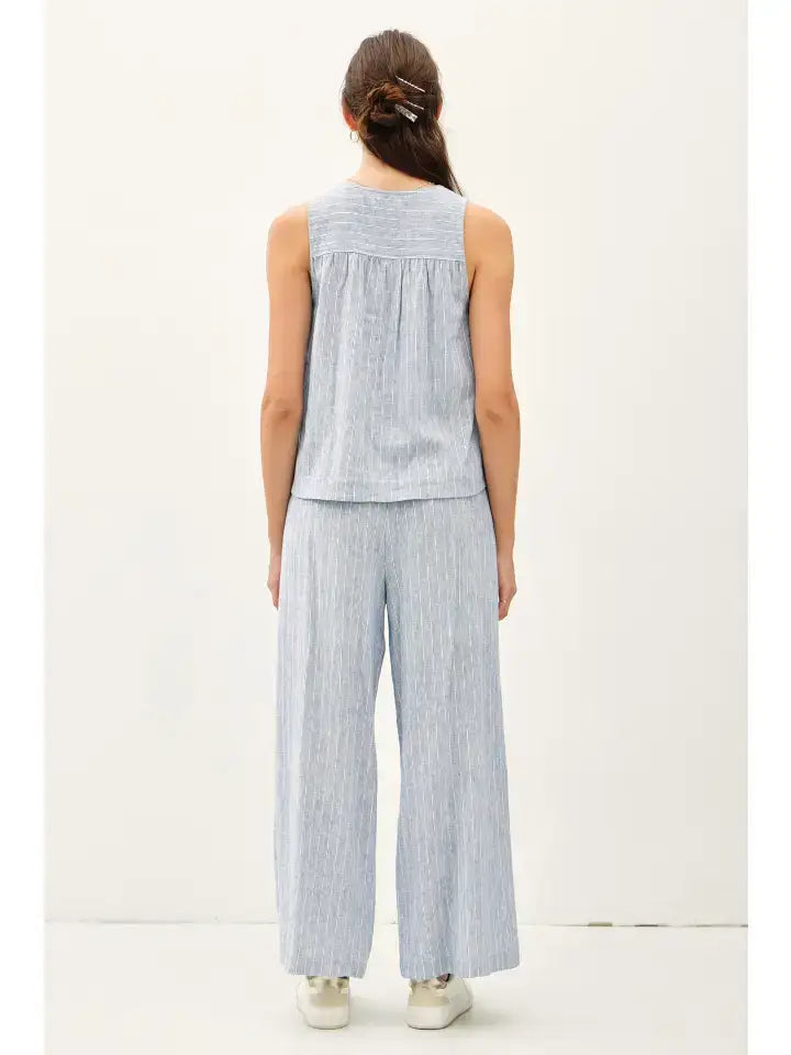 Woman wearing blue striped linen pantsuit paired with Boho striped Henley tank, stylish womens boho clothes