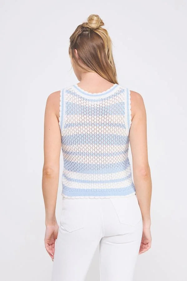 Woman wearing a blue and white striped crochet scallop edges knit tank top