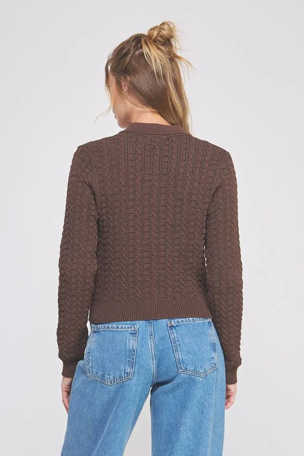Woman wearing a small cable knit button-down cardigan in brown fabric