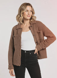 Woman wearing a brown fleece button-up Lois Sweater Jacket, a stylish sweater jacket option
