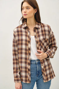 Woman wearing a brown plaid flannel shirt from the Ultra Soft Oversized Flannel collection