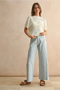 Woman’s casual outfit featuring floral stitch pattern denim pants for women’s boho chic clothing