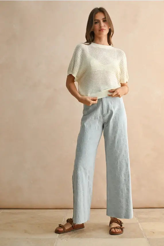 Woman’s casual outfit featuring floral stitch pattern denim pants for women’s boho chic clothing