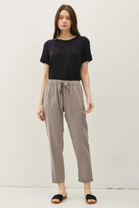 Woman’s casual outfit featuring TENCEL TAPERED PANTS showcasing elegant tapered pants style