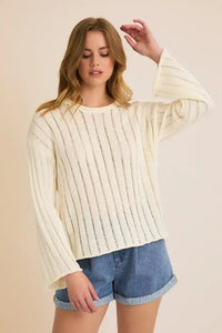 Cream-colored round neck long sleeve sweater showcased as a stylish long sleeve sweater for women