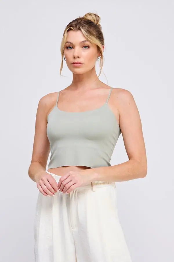 Woman wearing a smooth rib bralette tank with laser cut back detail