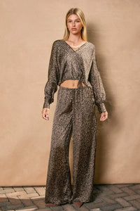 Woman wearing dark brown satin sand surplice top from Shop Daisy, boho chic clothing