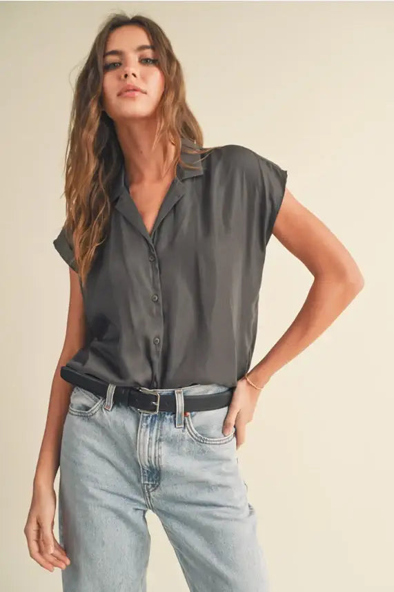 Woman’s gray cap sleeve shirt featuring a stylish button-down design