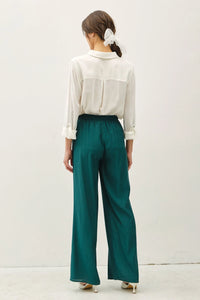 Woman wearing green crinkle wide leg pants with elastic drawstring waist, boho chic style