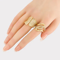 Woman’s hand wearing CZ Looped Ring with cubic zirconia centerpiece and triple gold plating