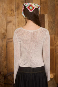 Woman wearing a crochet knit cardigan with a headscarf, showcasing the BELL SLEEVE CROCHET KNIT CARDIGAN