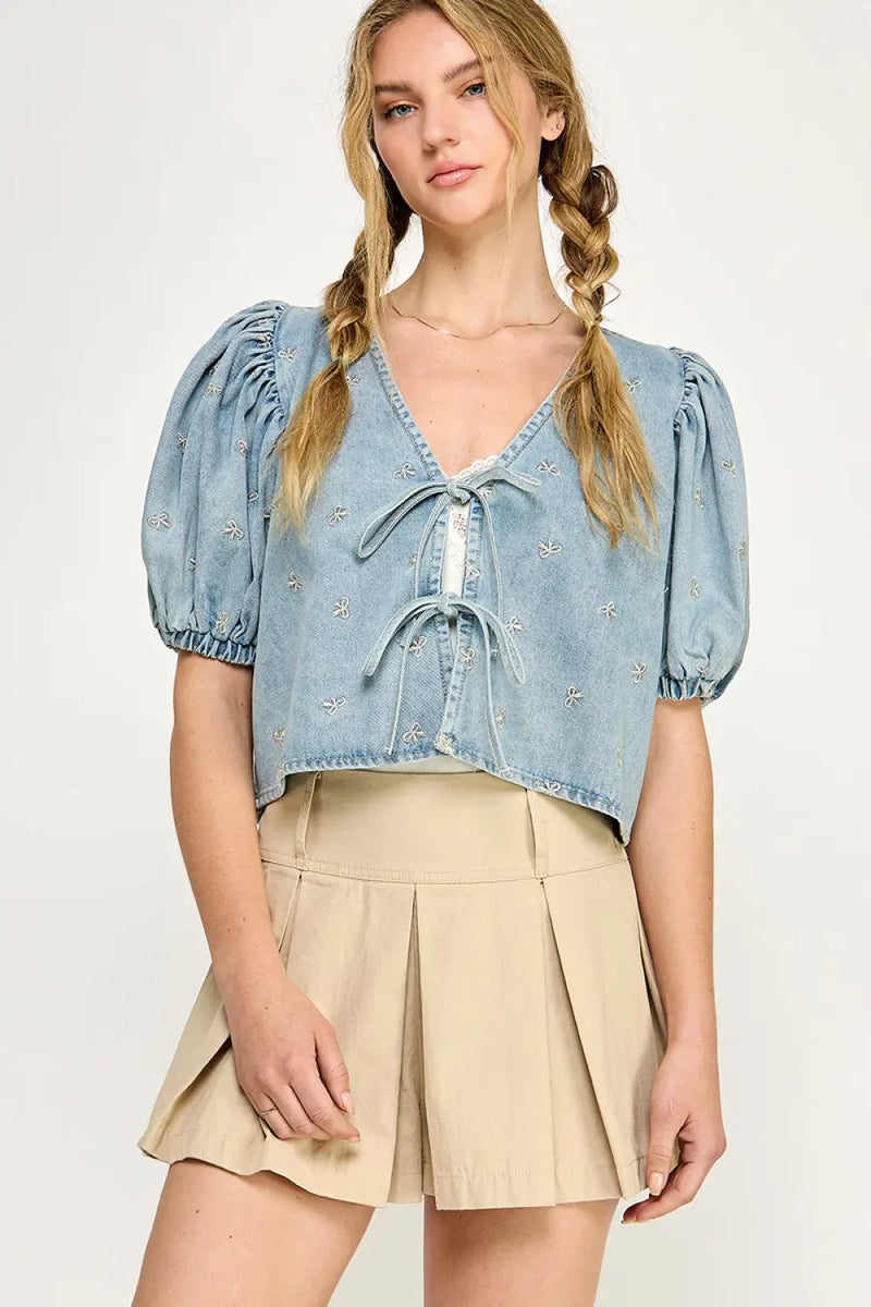Woman’s light blue bubble sleeves ribbon blouse with ribbon tie denim top and khaki skirt