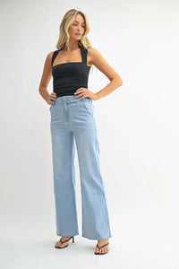 Woman wearing light blue denim belted wide leg jeans from JUST BLACK collection