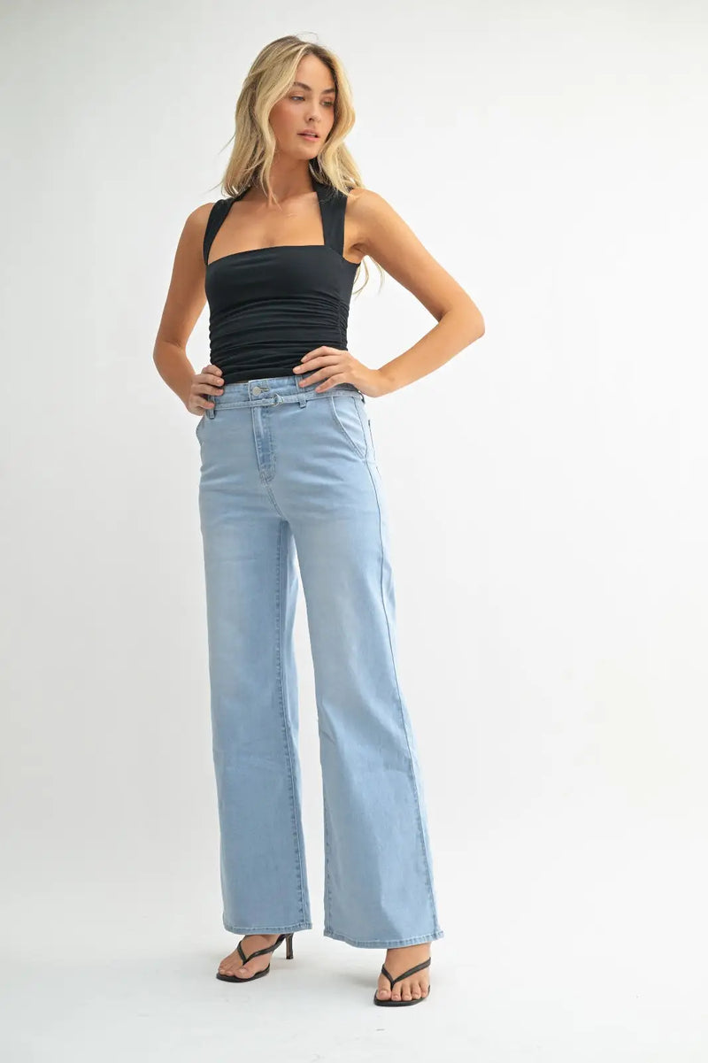 Woman wearing light blue denim belted wide leg jeans from JUST BLACK collection