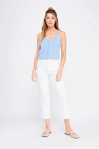 Woman wearing light blue PIONTELLE KNIT V NECK TANK TOP and white cropped pants for women’s boho chic clothing at Shop Daisy