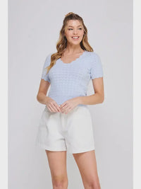 Light blue women’s boho chic scallop edges knit top with white shorts from Shop Daisy