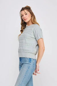 Woman’s light blue short sleeve patterned fine gauge knit dolman top