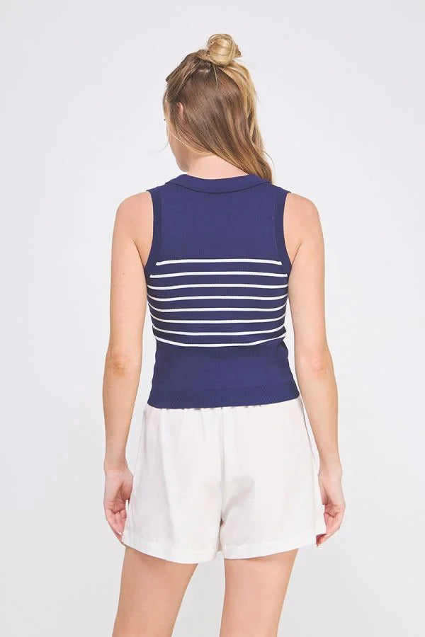 Woman wearing navy and white striped knit sleeveless polo tank top with white shorts