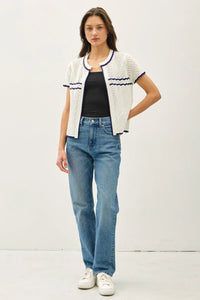 Woman wearing a crochet knit open cardigan with jeans, ideal for womens boho clothes