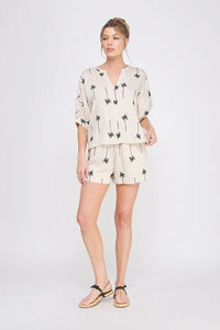Woman’s palm tree print shorts set from shop Daisy, perfect for women’s boho chic clothing