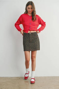Leopard print mini skirt for women’s boho chic clothing with multicolored buttons and red cardigan