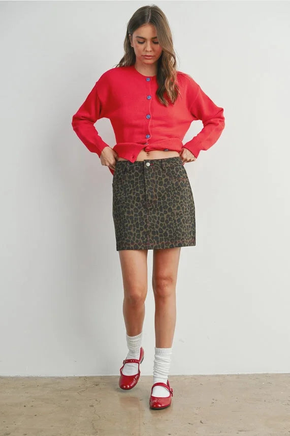 Leopard print mini skirt for women’s boho chic clothing with multicolored buttons and red cardigan