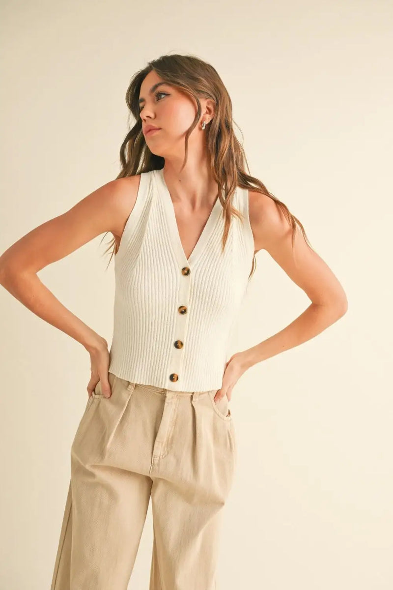 Woman’s ribbed knit button-down vest paired with khaki pants from Shop Daisy’s womens boho clothes