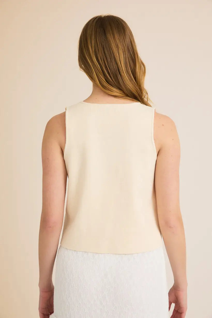 Woman’s sleeveless cream tie sweater vest, perfect for stylish layering and comfort