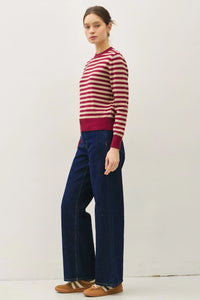 Woman wearing a classic stripe cropped sweater with wide-leg jeans for a stylish look