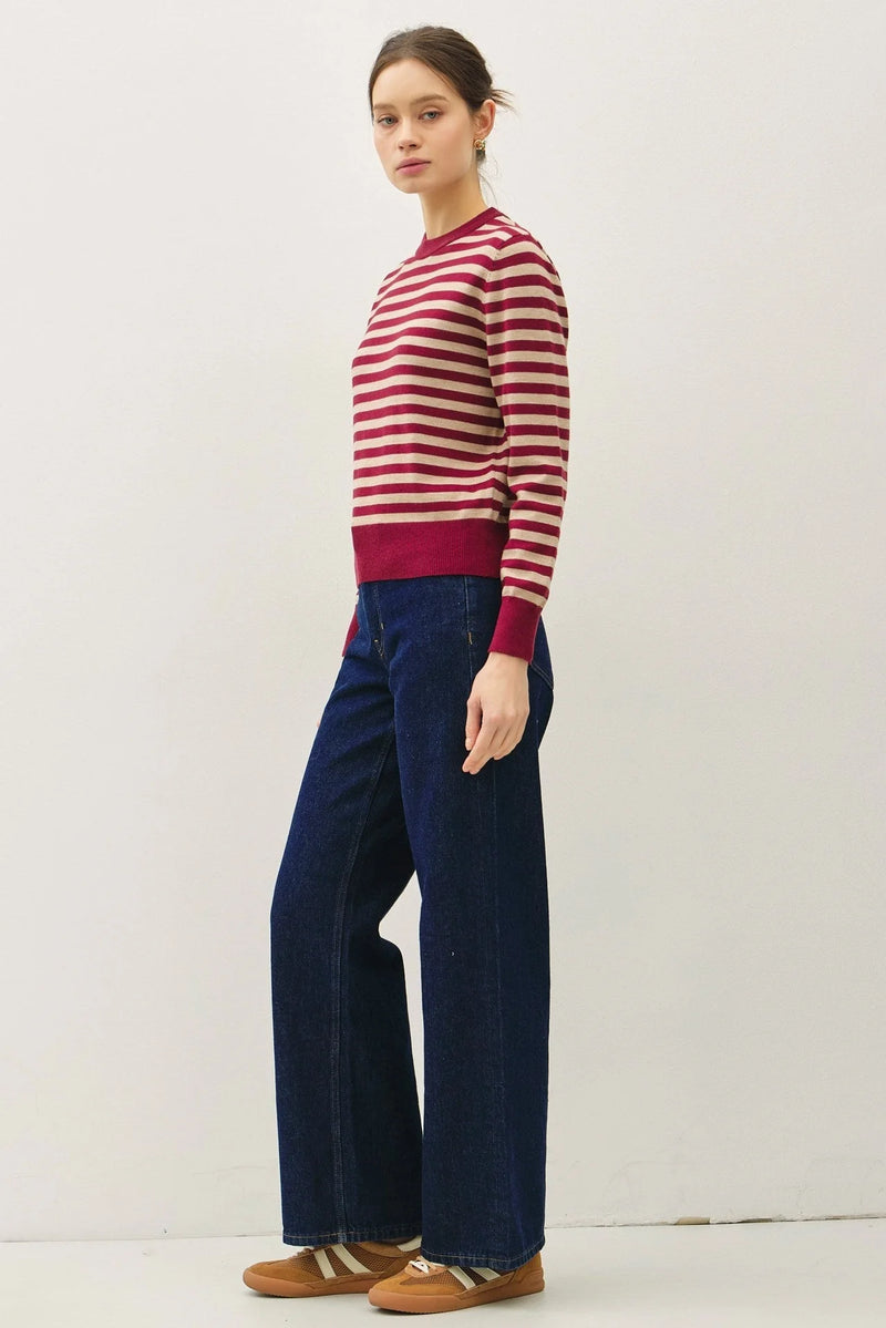 Woman wearing a classic stripe cropped sweater with wide-leg jeans for a stylish look