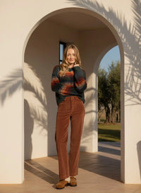 Woman wearing striped knit sweater and brown corduroy Supply Gladys Pants for a stylish look