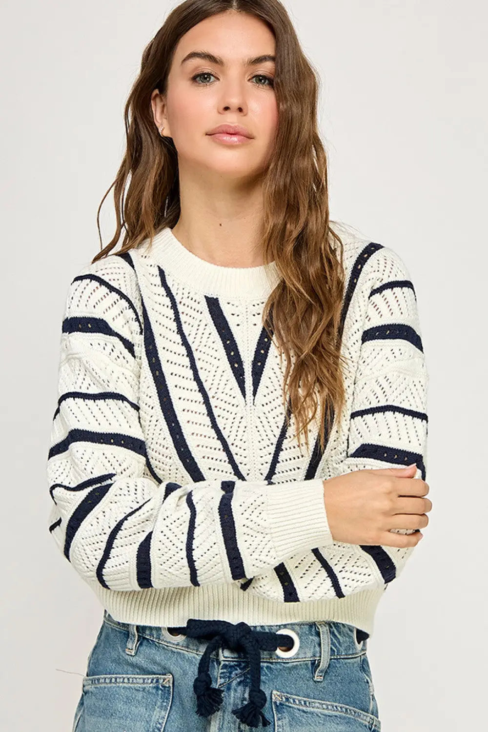Woman wearing V-Striped Knit Sweater from Shop Daisy, perfect for women’s boho chic clothing
