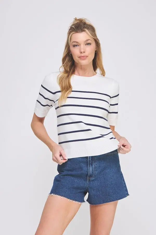 Woman wearing a soft fine short sleeve striped sweater top and denim shorts