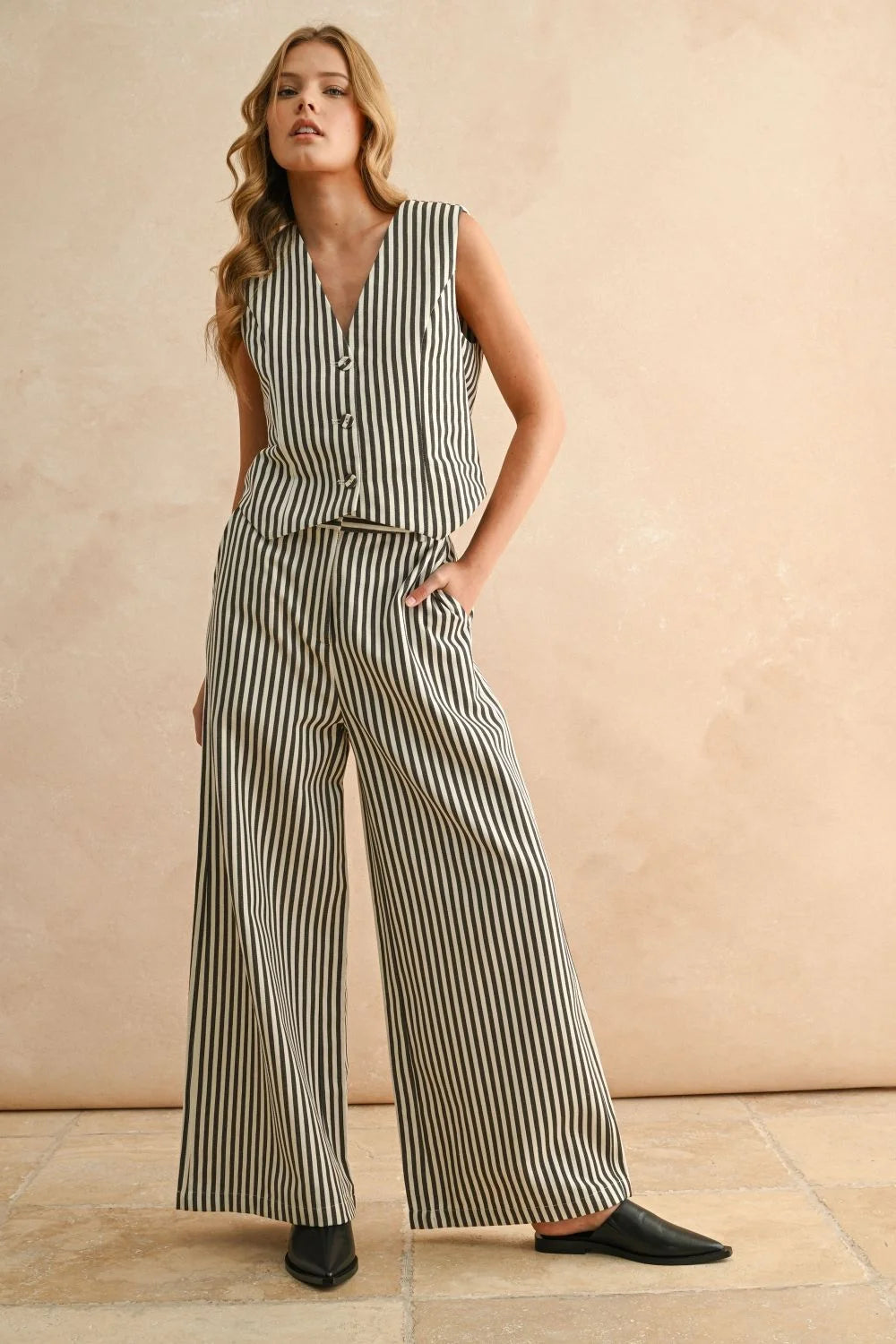 Woman wearing striped button sleeveless vest and matching wide-leg pants for women’s boho chic clothing at Shop Daisy