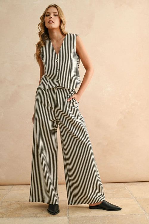 Woman wearing striped button sleeveless vest and matching wide-leg pants for women’s boho chic clothing at Shop Daisy