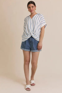 Woman wearing folded short sleeve stripe blouse with denim shorts outfit displayed