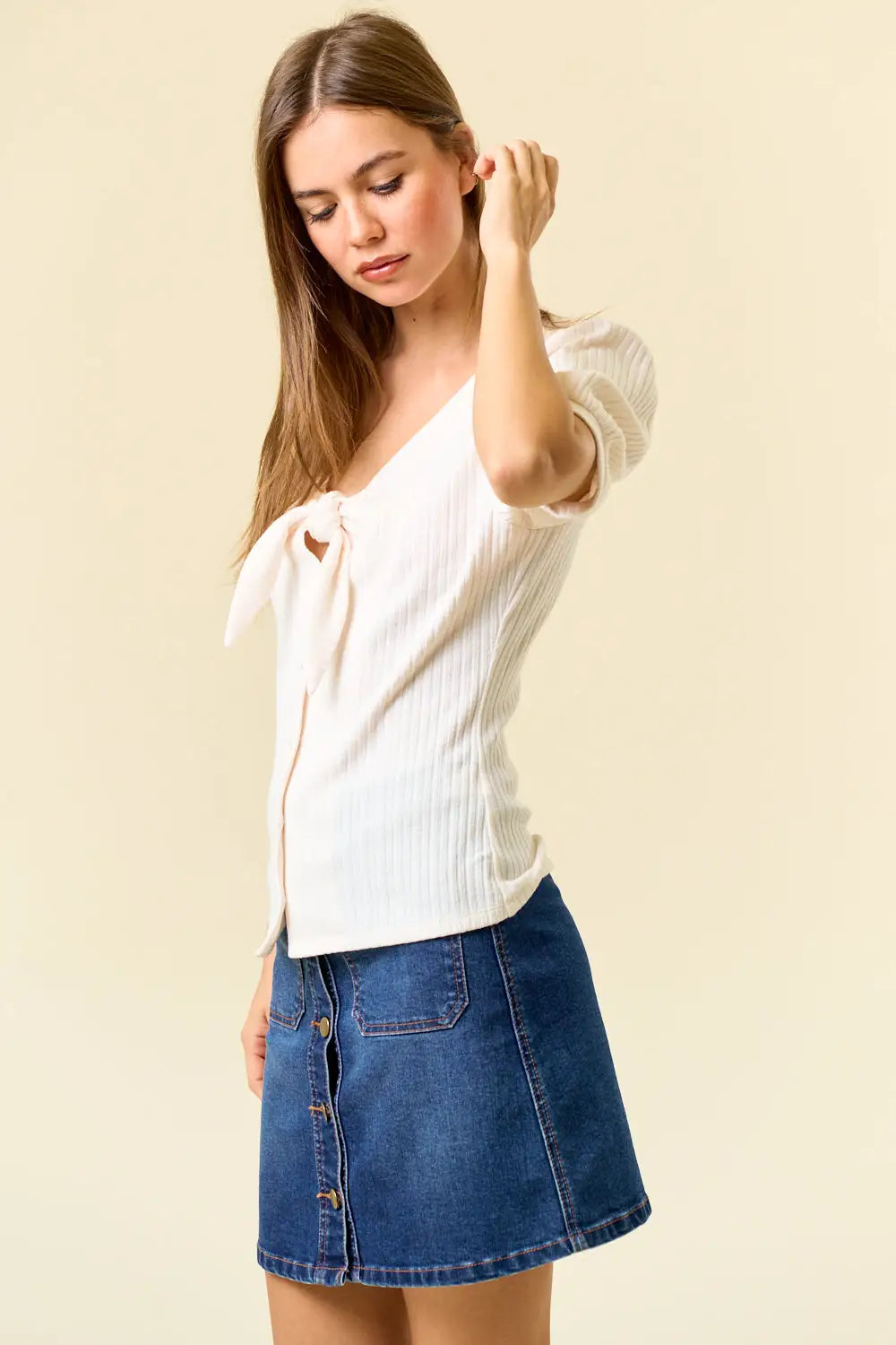 Woman wearing TIE FRONT POINTELLE KNIT BLOUSE with denim skirt, stylish knit blouse