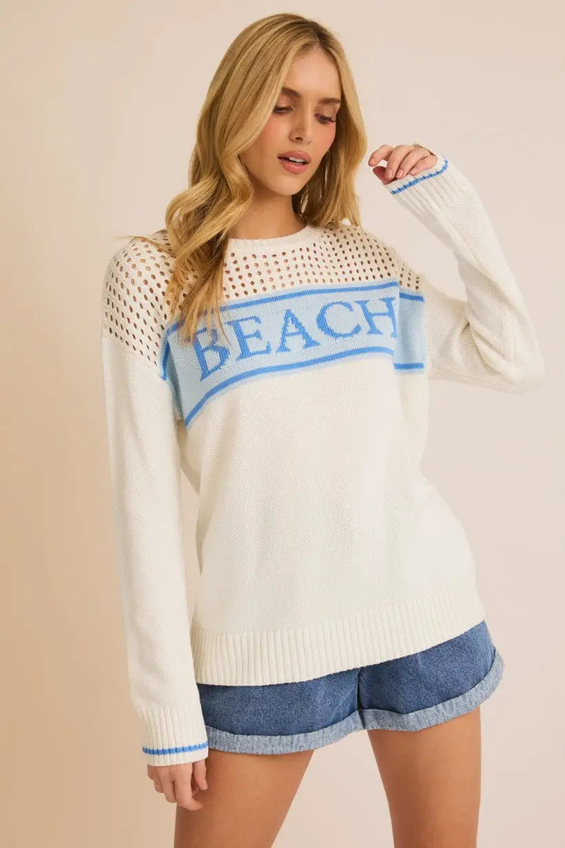 Lightweight women’s beach sweater featuring a round neck long sleeve design with blue trim