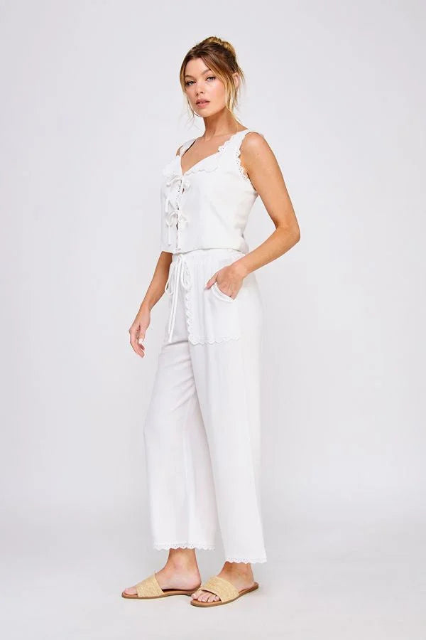 Woman wearing white linen blend elastic tie waist wide leg pants and matching top