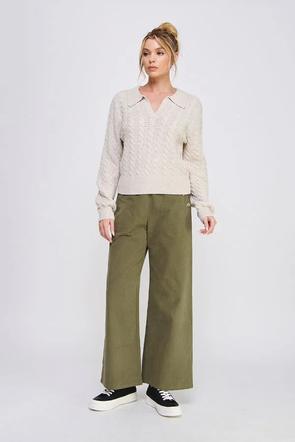 Women’s beige cable-knit sweater paired with soft heavy twill wide pants for a stylish look