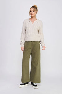 Women’s beige cable-knit sweater paired with soft heavy twill wide pants for a stylish look