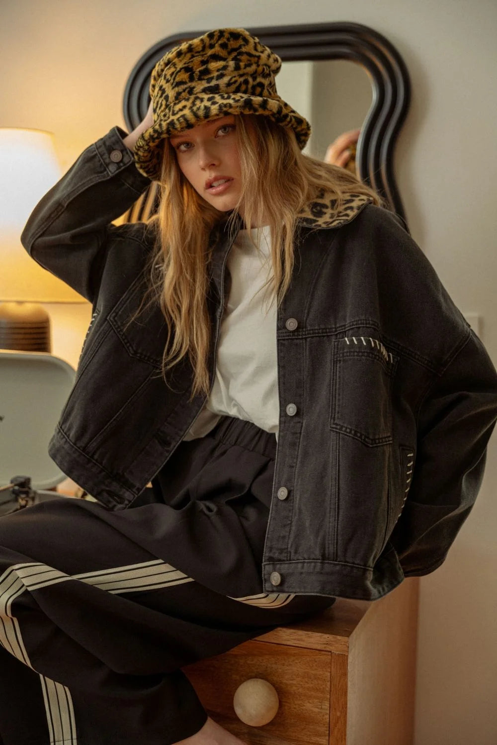 Women’s black denim jacket with leopard collar and matching bucket hat, stylish and trendy