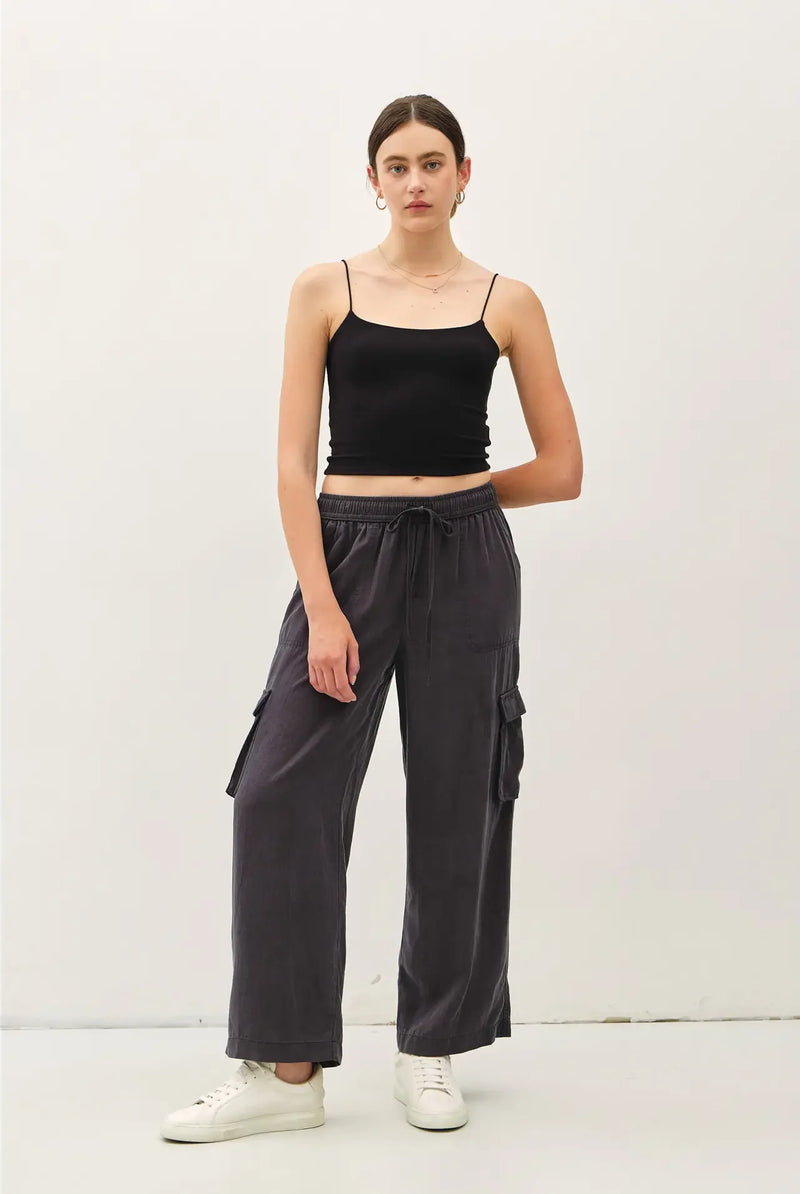 Women’s black spaghetti strap crop top paired with high rise drawstring wide leg cargo pants