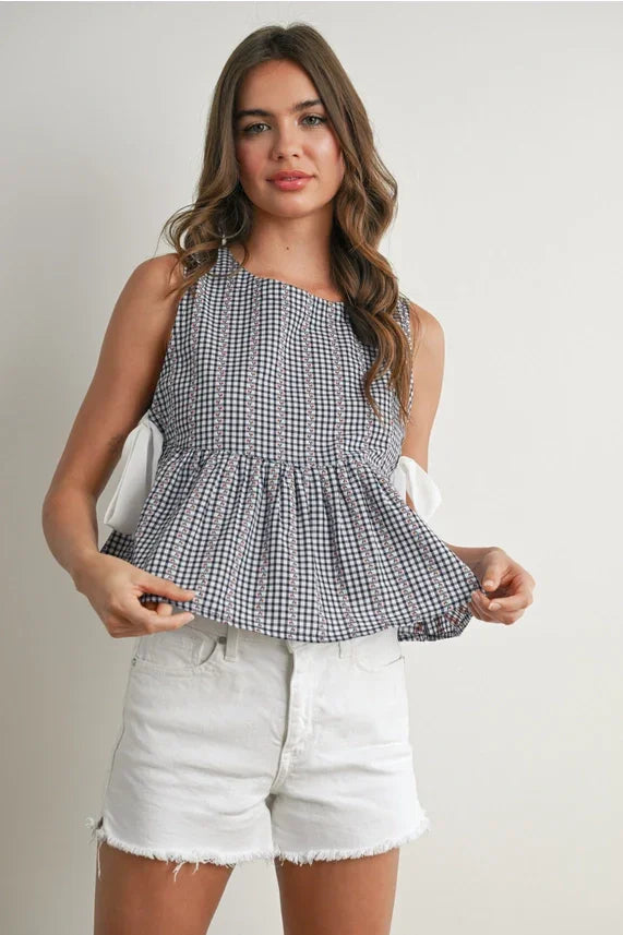 Women’s black and white gingham sky meadow peplum blouse with one shoulder strap and bows