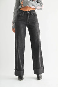 Women’s high rise cuffed wide leg jeans with cuffs paired with light gray argyle sweater
