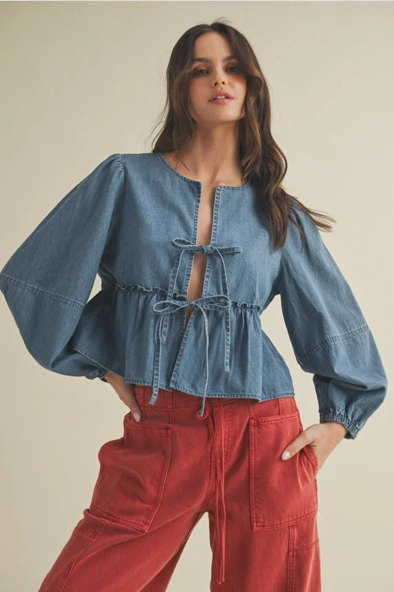 Women’s blue denim tie closure peplum top with ruffle hem paired with red cargo pants