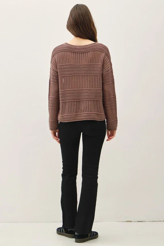 Women’s brown fisherman crochet sweater paired with black flared pants and sandals