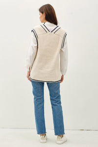 Women’s cream-colored ribbed knit sweater vest with black accent stripe in varsity style