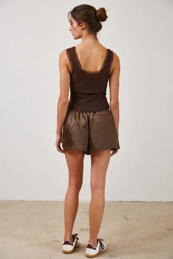 Women’s dark brown ribbed tank top with lace trim and matching faux leather shorts, featuring a mesh lace button design